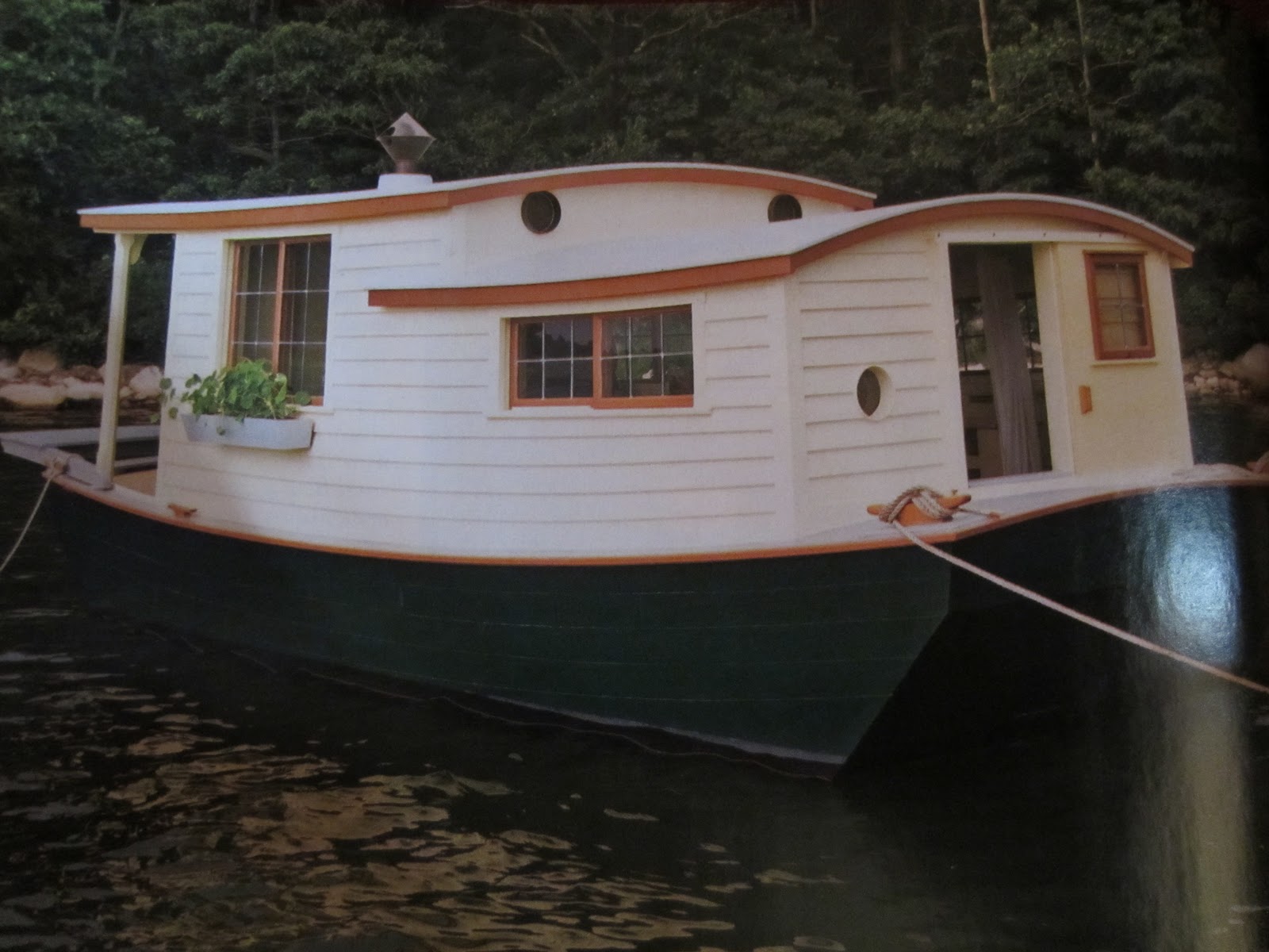 an unbelievable shantyboat/houseboat in wooden boat